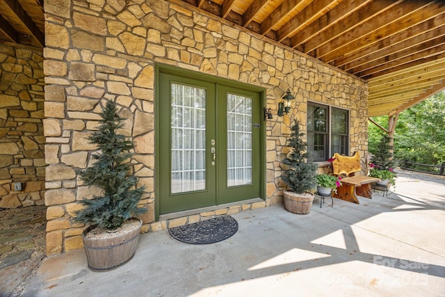 158 Raven Blvd, Lake Lure, NC 28746 - view of exterior entry featuring stone siding, french doors, and a patio