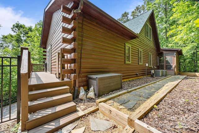 158 Raven Blvd, Lake Lure, NC 28746 - view of side of home featuring a sunroom, a wooden deck, cooling unit, a shingled roof, and log exterior