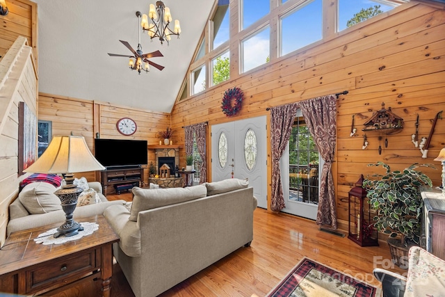 158 Raven Blvd, Lake Lure, NC 28746 - living room with wood walls, high vaulted ceiling, healthy amount of natural light, wood finished floors, and a chandelier