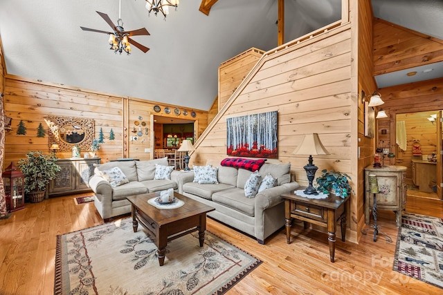 158 Raven Blvd, Lake Lure, NC 28746 - living area with wood walls, high vaulted ceiling, a ceiling fan, and wood finished floors