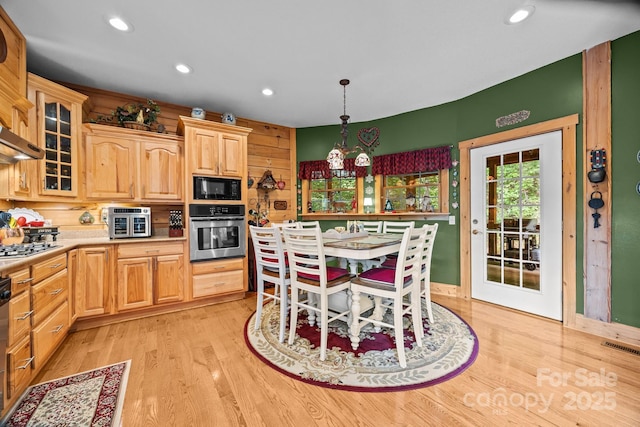 158 Raven Blvd, Lake Lure, NC 28746 - kitchen with appliances with stainless steel finishes, light countertops, light wood finished floors, recessed lighting, and glass insert cabinets
