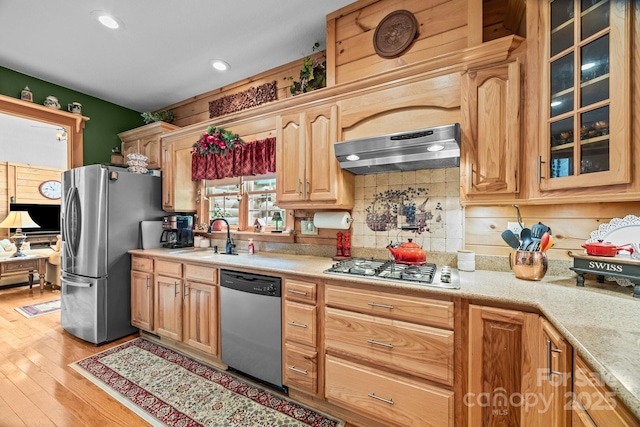 158 Raven Blvd, Lake Lure, NC 28746 - kitchen with appliances with stainless steel finishes, range hood, a sink, glass insert cabinets, and recessed lighting