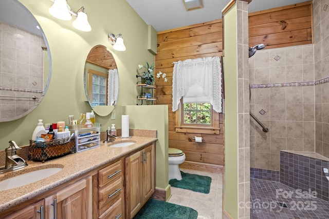 158 Raven Blvd, Lake Lure, NC 28746 - bathroom with tile patterned floors, double vanity, tiled shower, toilet, and wood walls