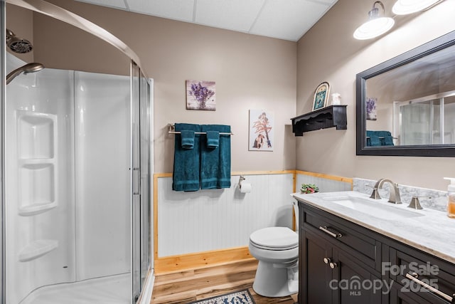158 Raven Blvd, Lake Lure, NC 28746 - bathroom with wainscoting, a stall shower, vanity, toilet, and wood finished floors