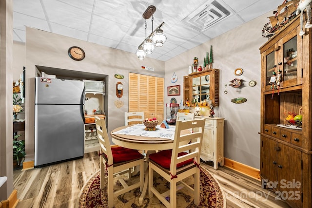 158 Raven Blvd, Lake Lure, NC 28746 - dining room featuring light wood-type flooring, a drop ceiling, and baseboards