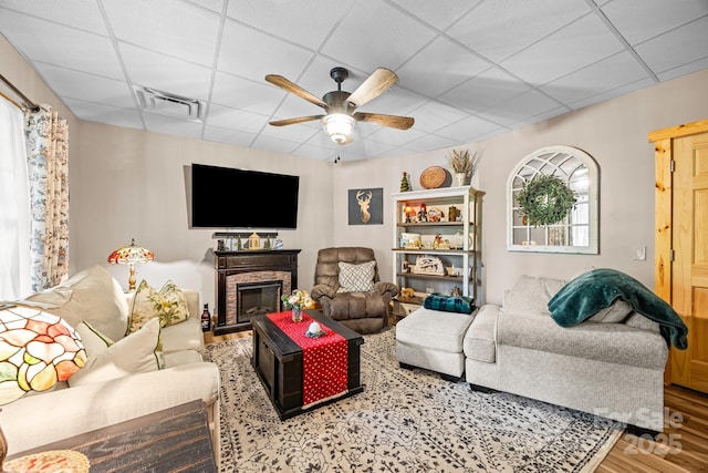 158 Raven Blvd, Lake Lure, NC 28746 - living room with ceiling fan, a drop ceiling, wood finished floors, and a glass covered fireplace