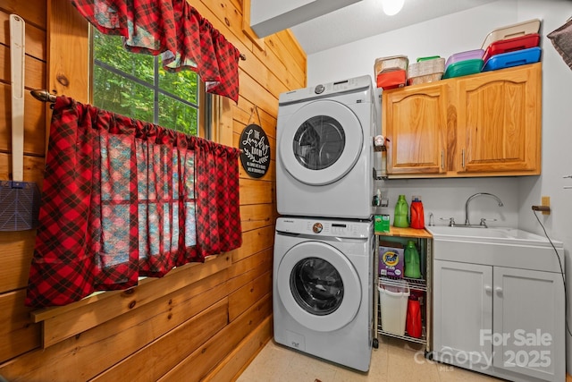 158 Raven Blvd, Lake Lure, NC 28746 - laundry room with stacked washer / drying machine, wood walls, cabinet space, and light flooring