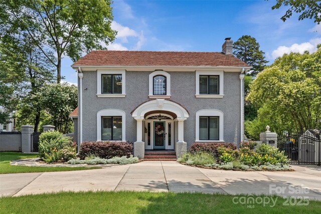 1619 Providence Rd, Charlotte, NC 28207 - view of front of property featuring a gate, a chimney, and stucco siding