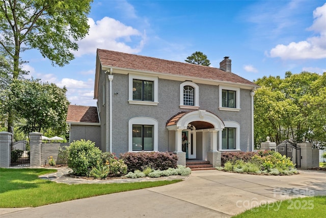 1619 Providence Rd, Charlotte, NC 28207 - view of front of property featuring a gate, a chimney, and stucco siding