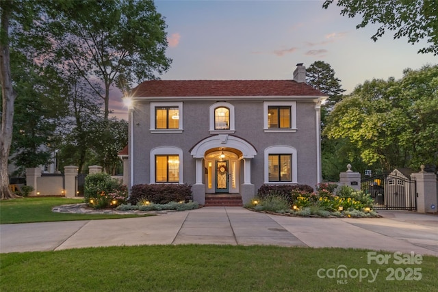 1619 Providence Rd, Charlotte, NC 28207 - view of front facade featuring a gate, a chimney, and stucco siding