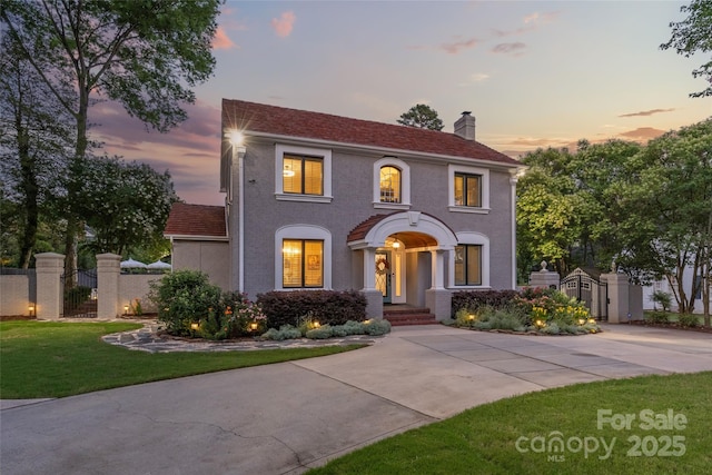 1619 Providence Rd, Charlotte, NC 28207 - view of front facade featuring a gate, a chimney, and stucco siding