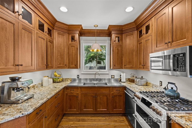 1619 Providence Rd, Charlotte, NC 28207 - kitchen with appliances with stainless steel finishes, a sink, brown cabinetry, and stainless steel countertops