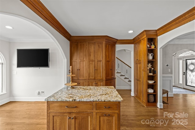 1619 Providence Rd, Charlotte, NC 28207 - kitchen featuring arched walkways, dark wood finished floors, light stone countertops, ornamental molding, and recessed lighting
