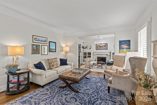 1619 Providence Rd, Charlotte, NC 28207 - living area with wood finished floors, crown molding, a chandelier, a glass covered fireplace, and baseboards
