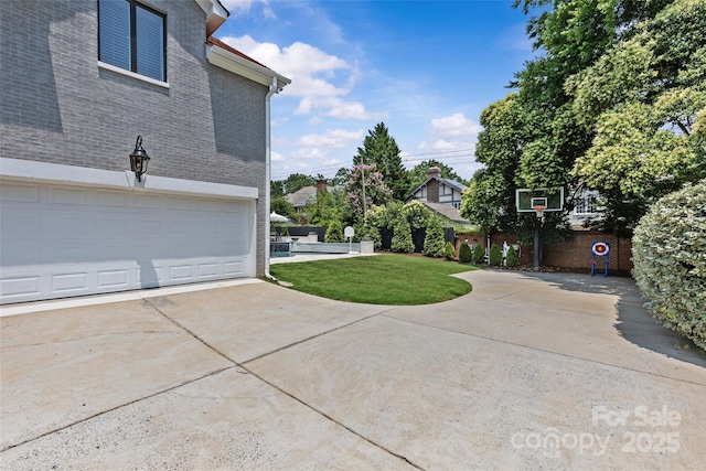 1619 Providence Rd, Charlotte, NC 28207 - view of side of home featuring a lawn, a garage, brick siding, and driveway