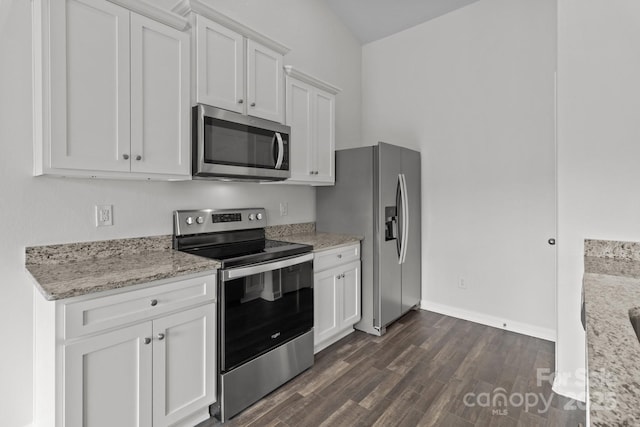 5314 Upton Pl, Charlotte, NC 28215 - kitchen featuring appliances with stainless steel finishes, white cabinets, dark wood-type flooring, and light stone counters