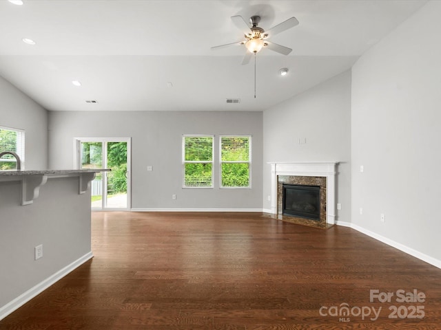 1660 Beleek Ridge Ln, Lake Wylie, SC 29710 - unfurnished living room with healthy amount of natural light, wood finished floors, ceiling fan, lofted ceiling, and baseboards