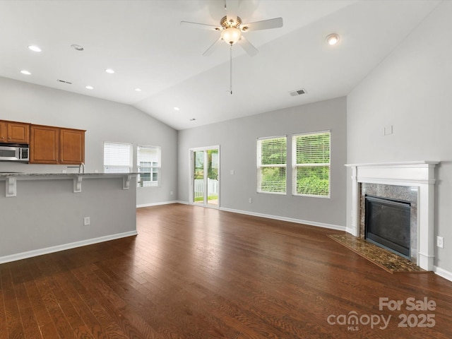 1660 Beleek Ridge Ln, Lake Wylie, SC 29710 - unfurnished living room with vaulted ceiling, dark wood finished floors, a ceiling fan, a premium fireplace, and baseboards