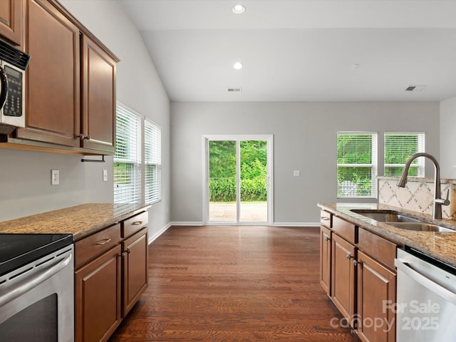 1660 Beleek Ridge Ln, Lake Wylie, SC 29710 - kitchen featuring appliances with stainless steel finishes, a sink, dark wood finished floors, light stone countertops, and recessed lighting