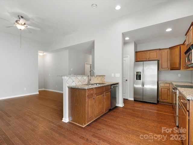 1660 Beleek Ridge Ln, Lake Wylie, SC 29710 - kitchen with appliances with stainless steel finishes, a sink, a ceiling fan, brown cabinets, and recessed lighting