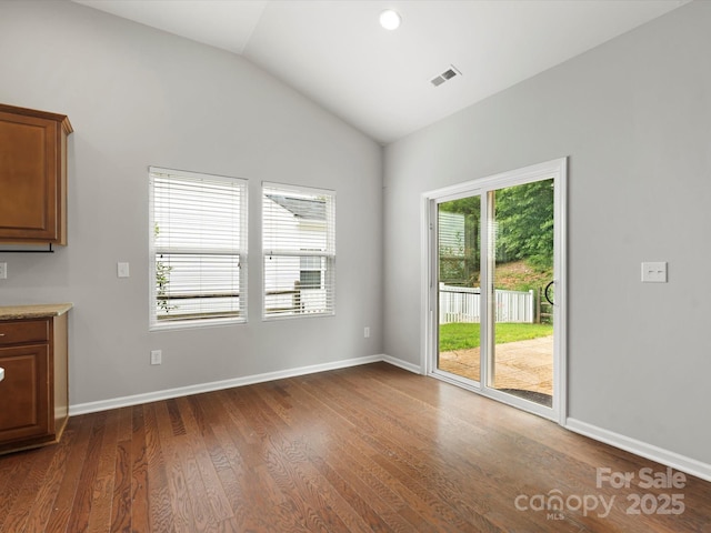 1660 Beleek Ridge Ln, Lake Wylie, SC 29710 - unfurnished dining area featuring vaulted ceiling, dark wood-type flooring, and baseboards