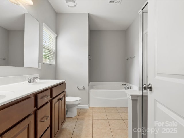 1660 Beleek Ridge Ln, Lake Wylie, SC 29710 - bathroom featuring a garden tub, double vanity, toilet, tile patterned floors, and baseboards
