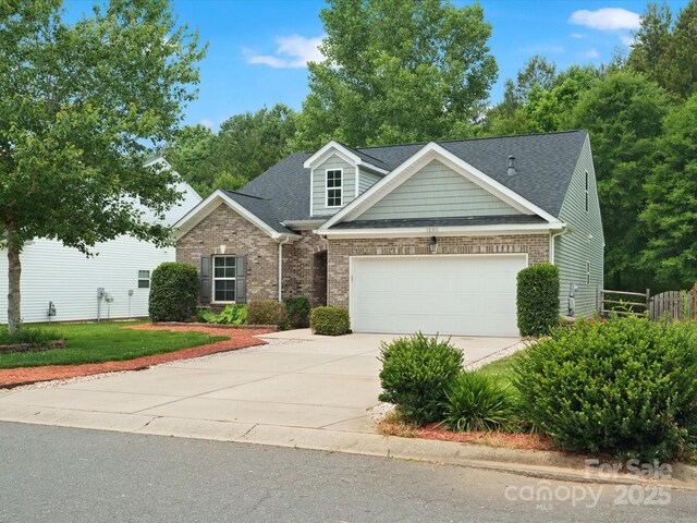1660 Beleek Ridge Ln, Lake Wylie, SC 29710 - view of front of house with driveway, a garage, a shingled roof, and brick siding