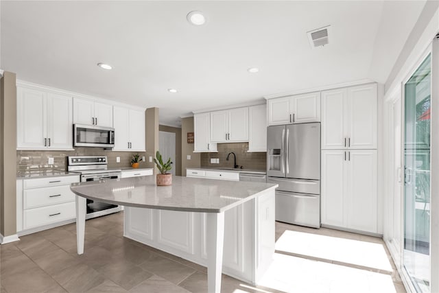 22 Honeysuckle Ln, Clover, SC 29710 - kitchen featuring stainless steel appliances, tasteful backsplash, a center island, white cabinetry, and recessed lighting