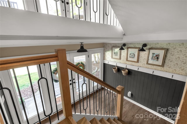 22 Honeysuckle Ln, Clover, SC 29710 - staircase with healthy amount of natural light, wood finished floors, wallpapered walls, and wainscoting