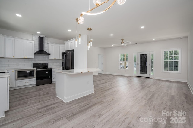 520 E Main St, Dallas, NC 28034 - kitchen featuring wall chimney range hood, electric stove, black refrigerator with ice dispenser, light countertops, and decorative backsplash