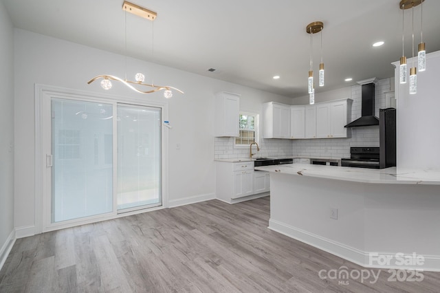 520 E Main St, Dallas, NC 28034 - kitchen with wall chimney exhaust hood, black / electric stove, light wood-style flooring, backsplash, and white cabinets