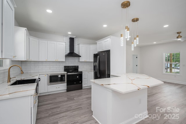 520 E Main St, Dallas, NC 28034 - kitchen featuring wall chimney range hood, black appliances, a sink, backsplash, and light wood finished floors