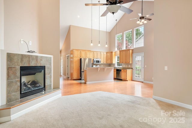 2695 Queens Rd, Lincolnton, NC 28092 - kitchen with open floor plan, stainless steel appliances, high vaulted ceiling, light carpet, and ceiling fan