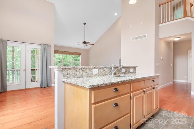 2695 Queens Rd, Lincolnton, NC 28092 - kitchen featuring high vaulted ceiling, a sink, light wood-type flooring, a ceiling fan, and light brown cabinets