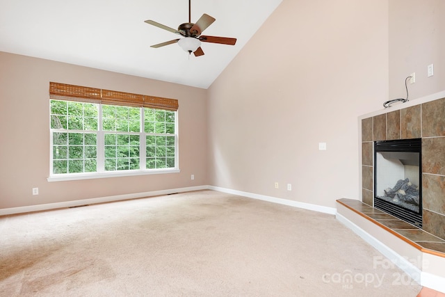 2695 Queens Rd, Lincolnton, NC 28092 - unfurnished living room with high vaulted ceiling, light colored carpet, baseboards, a tile fireplace, and ceiling fan