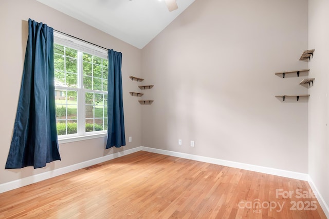 2695 Queens Rd, Lincolnton, NC 28092 - empty room with wood finished floors, healthy amount of natural light, baseboards, vaulted ceiling, and a ceiling fan