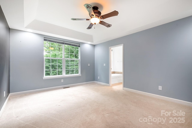 2695 Queens Rd, Lincolnton, NC 28092 - empty room with a ceiling fan, light carpet, a raised ceiling, and baseboards