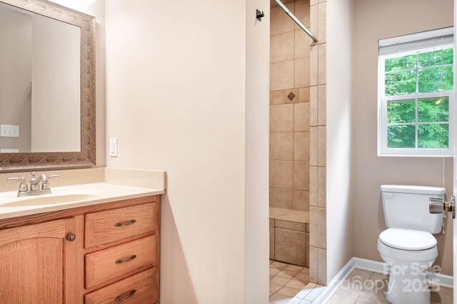 2695 Queens Rd, Lincolnton, NC 28092 - bathroom featuring vanity, toilet, tiled shower, tile patterned flooring, and baseboards