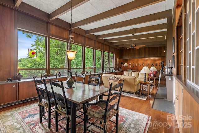 21 Rhododendron Rd, Black Mountain, NC 28711 - dining space with beamed ceiling, wood finished floors, wood walls, and a ceiling fan
