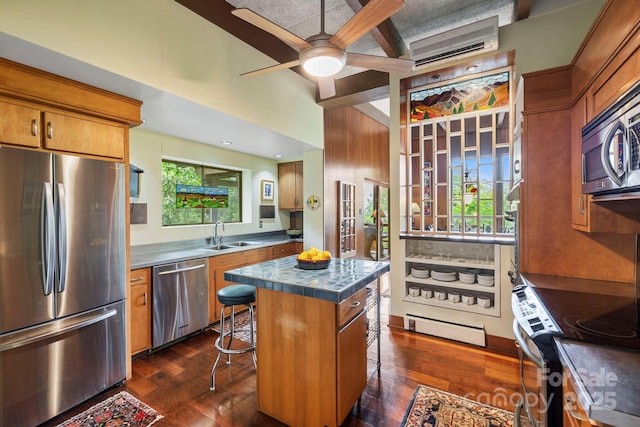 21 Rhododendron Rd, Black Mountain, NC 28711 - kitchen featuring appliances with stainless steel finishes, a breakfast bar area, a sink, a ceiling fan, and a wall unit AC
