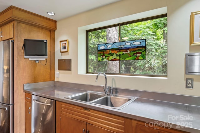 21 Rhododendron Rd, Black Mountain, NC 28711 - kitchen featuring stainless steel counters, appliances with stainless steel finishes, a sink, and brown cabinets