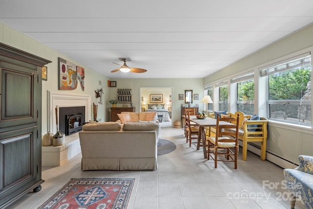 21 Rhododendron Rd, Black Mountain, NC 28711 - living room featuring a ceiling fan, light tile patterned floors, baseboard heating, and a fireplace with raised hearth