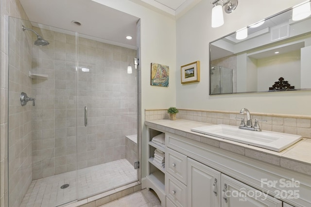 21 Rhododendron Rd, Black Mountain, NC 28711 - bathroom with vanity, a stall shower, tile patterned flooring, ornamental molding, and tile walls