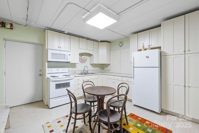 21 Rhododendron Rd, Black Mountain, NC 28711 - kitchen with white appliances, a sink, light tile patterned floors, and light countertops