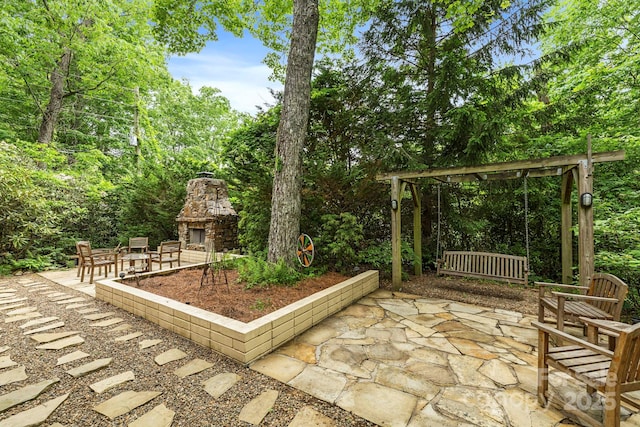 21 Rhododendron Rd, Black Mountain, NC 28711 - view of patio with an outdoor stone fireplace and view of scattered trees