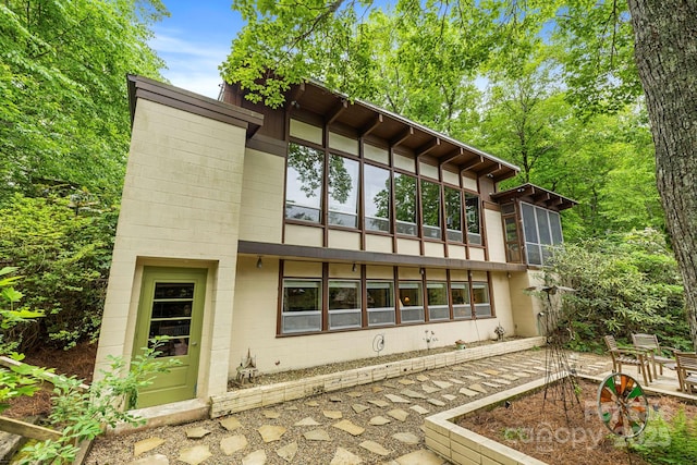 21 Rhododendron Rd, Black Mountain, NC 28711 - rear view of house with a patio and concrete block siding