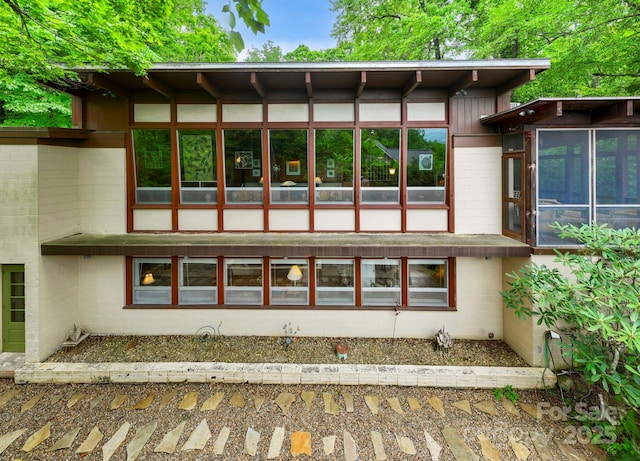 21 Rhododendron Rd, Black Mountain, NC 28711 - rear view of property featuring a sunroom and concrete block siding