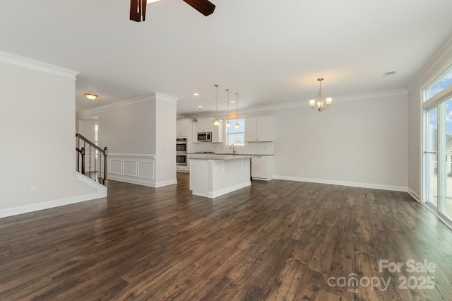 732 Altamonte Dr, Clover, SC 29710 - unfurnished living room featuring a chandelier, healthy amount of natural light, dark wood-style floors, a sink, and crown molding