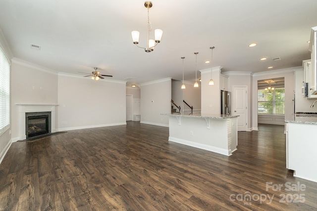 732 Altamonte Dr, Clover, SC 29710 - unfurnished living room with a chandelier, a ceiling fan, crown molding, dark wood finished floors, and recessed lighting