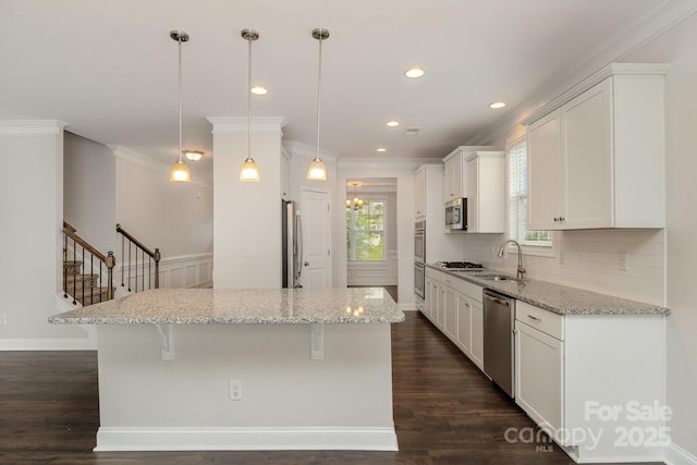 732 Altamonte Dr, Clover, SC 29710 - kitchen featuring stainless steel appliances, a sink, a kitchen breakfast bar, white cabinetry, and dark wood finished floors